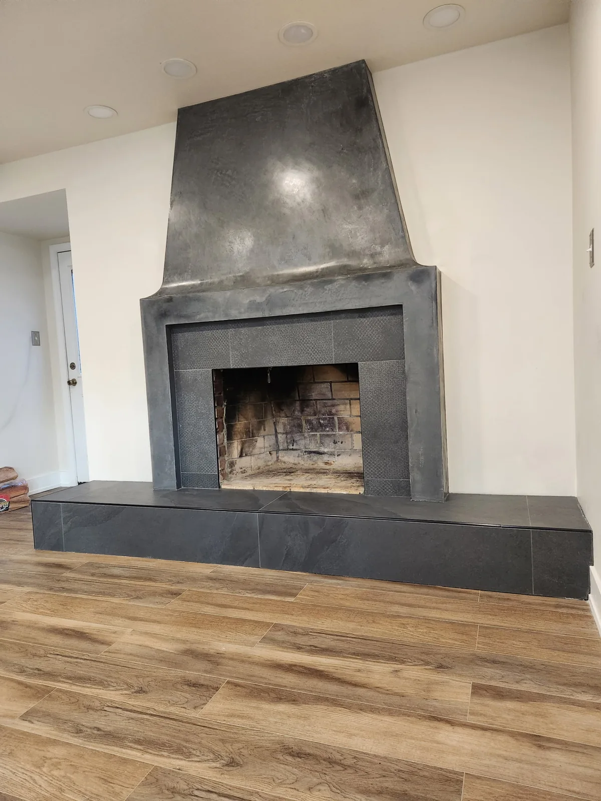 Dark decorative fireplace surround with a raised hearth